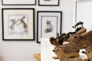 Picture of hand made wood/stone animal ornaments including a haire, hedgehog and more.