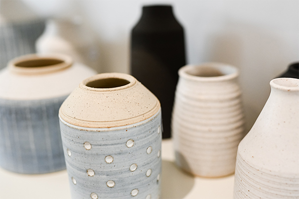 Multiple picture of vases of different neutral tones, some have patterns and texture to them.